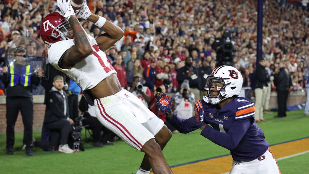Nov 25, 2023; Auburn, Alabama, USA; Alabama Crimson Tide wide receiver Isaiah Bond (17) scores the game winning touchdown over Auburn Tigers cornerback D.J. James (4) during the fourth quarter at Jordan-Hare Stadium. Mandatory Credit: John Reed-USA TODAY Sports
